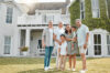 Family standing confidently in front of their home with a serene sunset, symbolizing financial freedom through SureWealth strategies