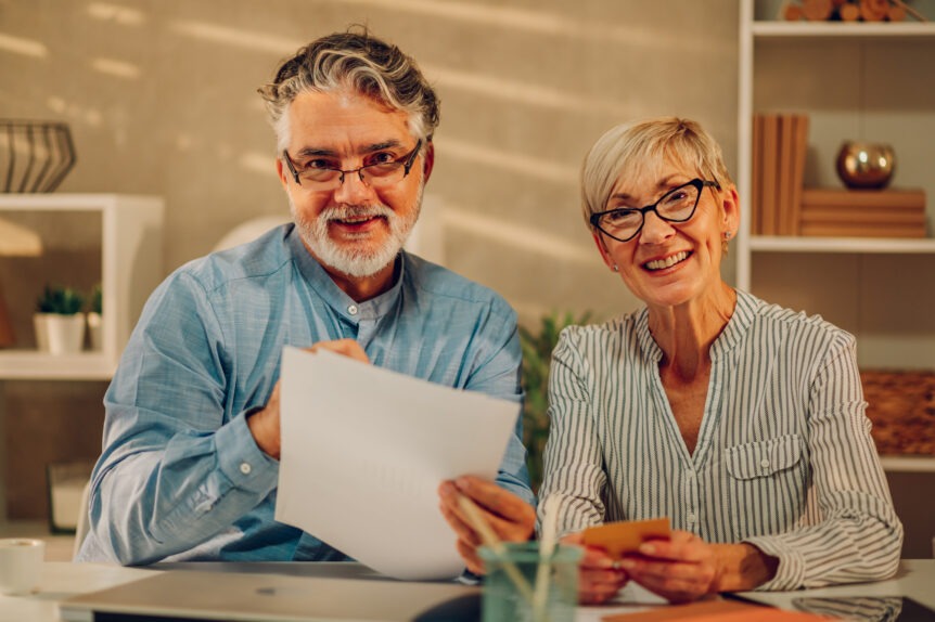 Sure Wealth Strategist explaining tax-efficient retirement strategies to senior couple using visual aids