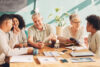 Happy distracted business people in a meeting