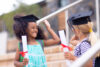 Schoolgirls with mortarboards celebrating graduation